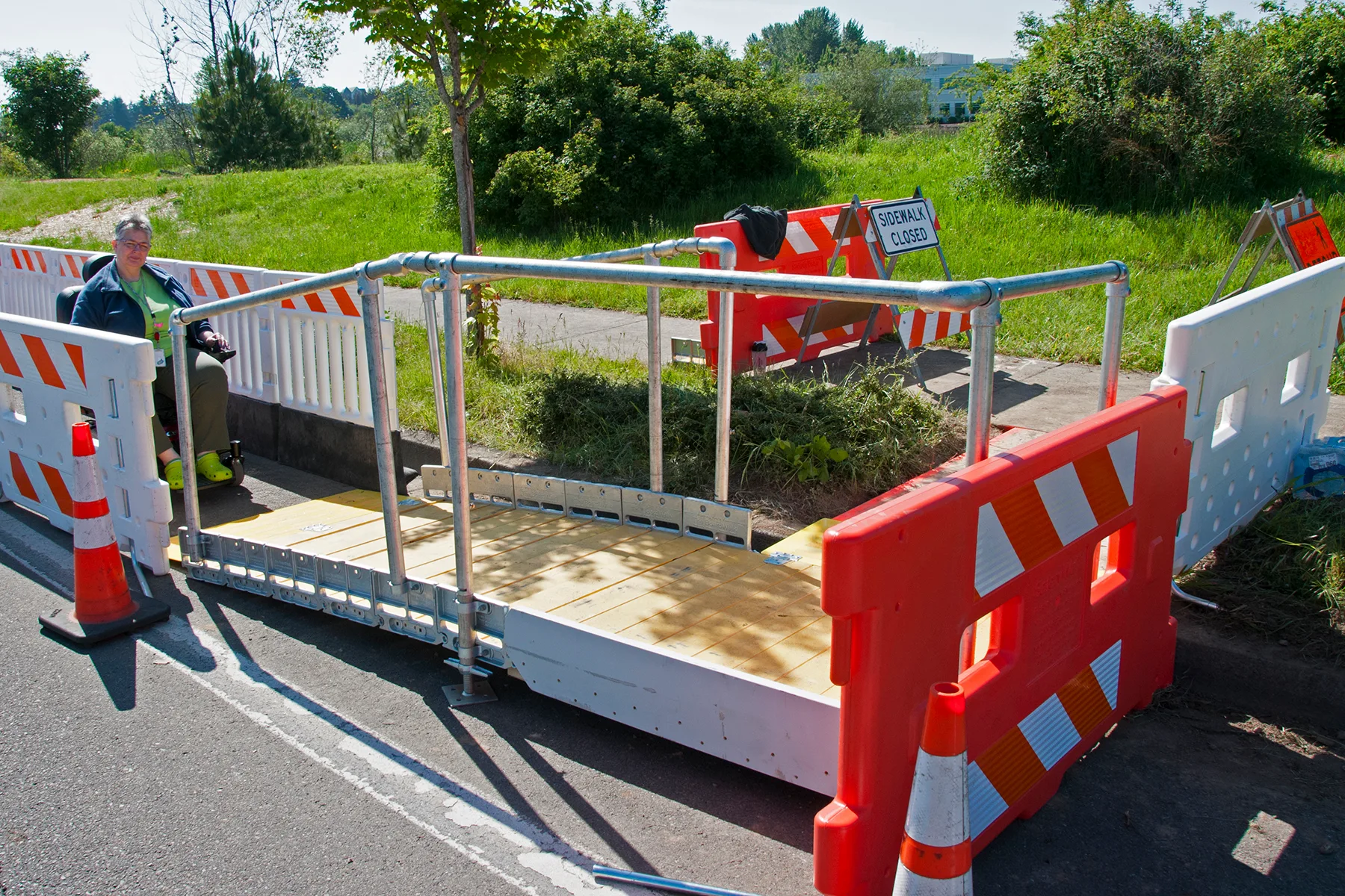 ADA compliant ramp entrance to protected pedestrian channel. Art workshop destinations accessibility: what to ask