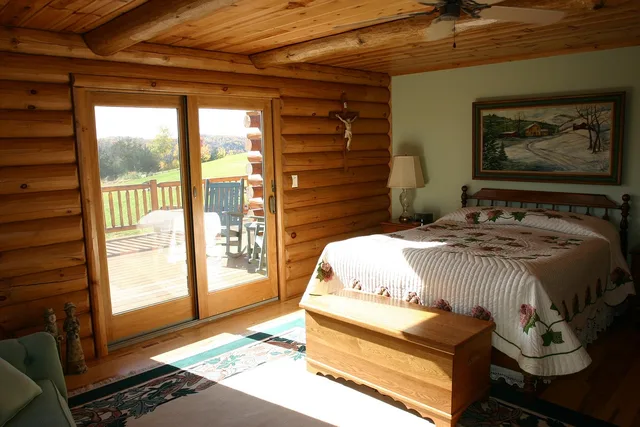 master bedroom, bed, logs, cabin, log home, bedroom, interior, furniture, room, brown home, brown room, brown bed, brown bedroom, brown interior, cabin, cabin, cabin, cabin, cabin, bedroom, bedroom. What a well-planned retreat weekend really costs, line by line