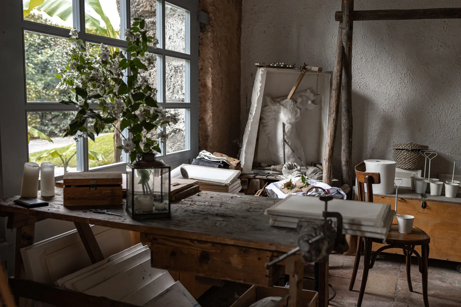 Beautiful rustic studio with vintage decor, wooden furniture, and natural light streaming through large windows. Building an honest creative retreat cost estimate for 2027