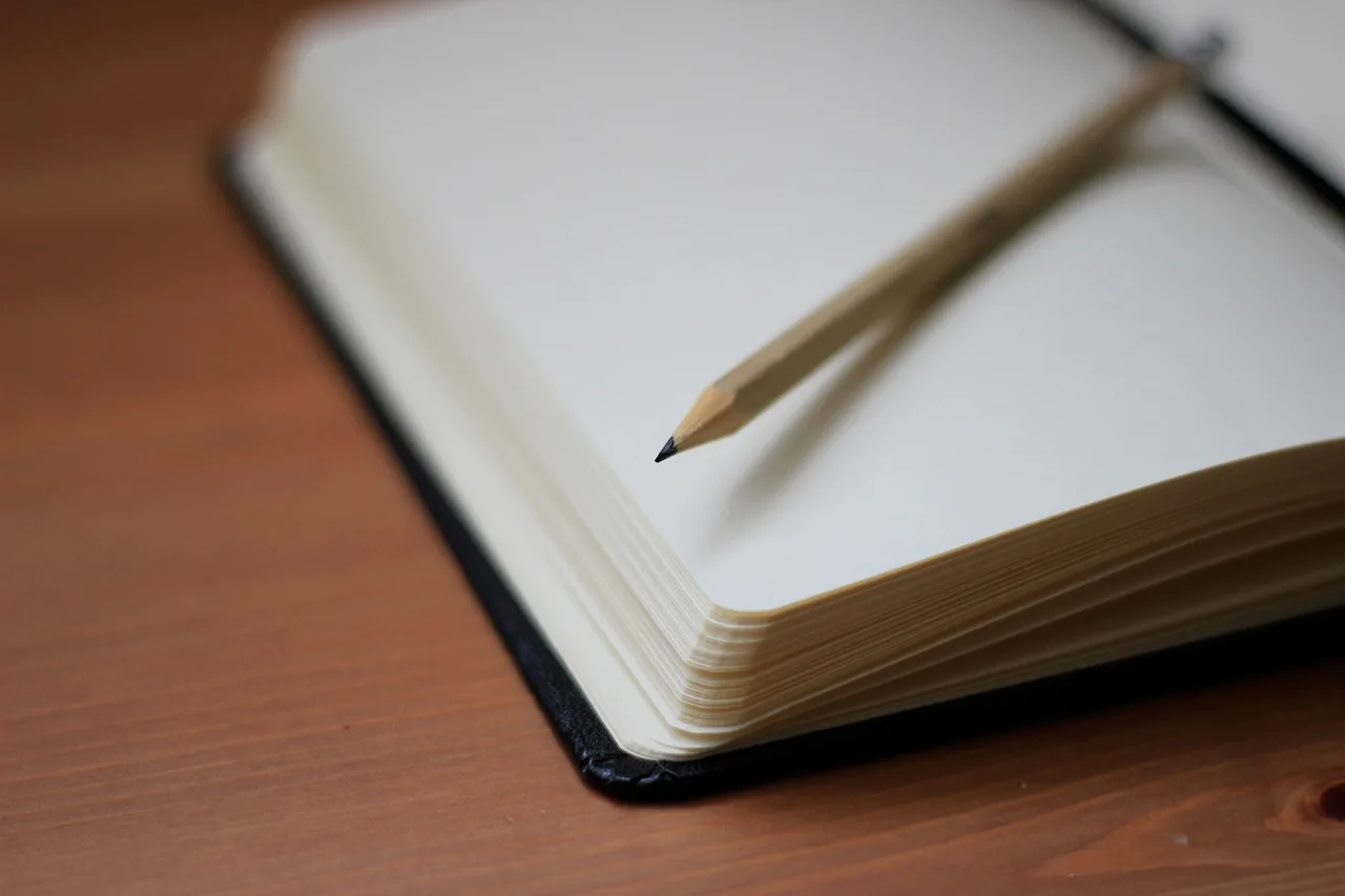 pencil, write, notebook, paper, desk, wooden, brown laptop, brown writing, brown desk. A writing retreat stay packing list built around protecting the manuscript